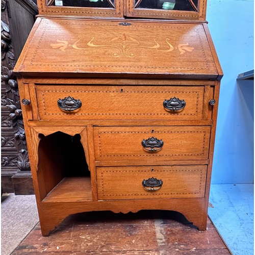 288 - A Liberty 'style' oak bureau bookcase, the top with adjustable shelves enclosing by glazed doors, sl... 