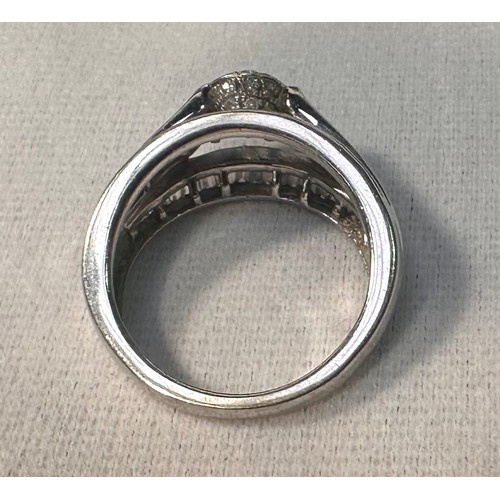 76 - A 9ct white gold dress ring, set with three rows of baguette diamond in a channel setting, leading u... 