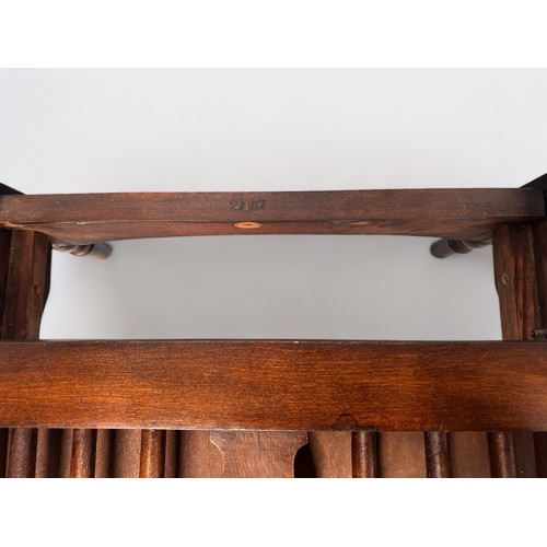 272 - A 20th Century oak metamorphic low-seated reclining chair, Windsor and spindle back and sides, raise... 