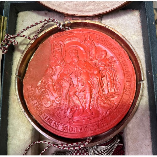 480 - An Edward VII red wax seal, with cord running through centre, housed in circular copper skippet by G... 