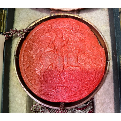 480 - An Edward VII red wax seal, with cord running through centre, housed in circular copper skippet by G... 