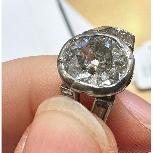 109 - A platinum and diamond ring, rub-over set with an oval-shaped Victorian cut diamond to the centre, e... 