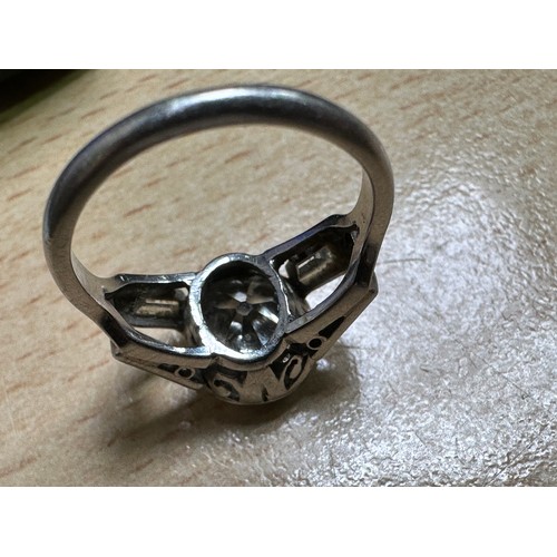 109 - A platinum and diamond ring, rub-over set with an oval-shaped Victorian cut diamond to the centre, e... 