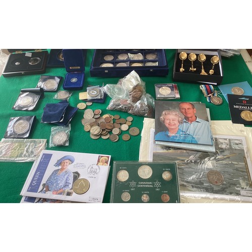 303 - A box containing coins and other collectables (see first photo for all items), including a display b... 