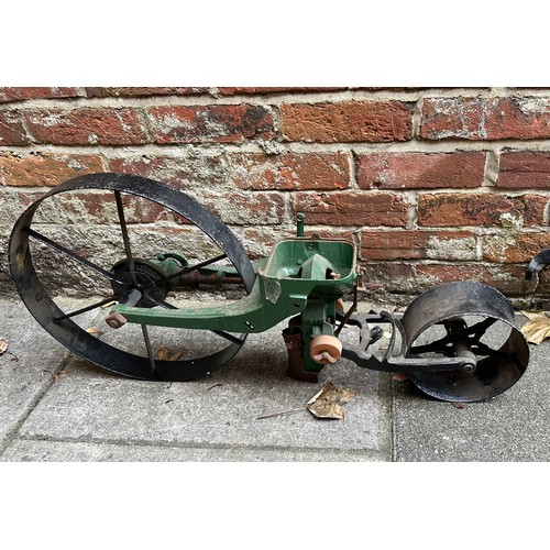 549 - A cast iron garden seed drill, together with a set of iron balance scales