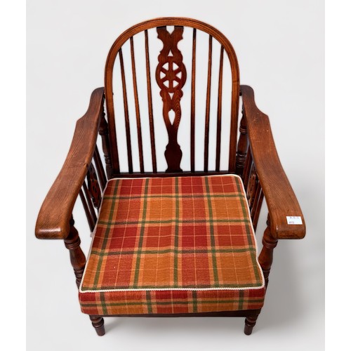 502 - A 20th Century stained beech and ash metamorphic low-seated reclining chair, Windsor 'style' wheel a... 