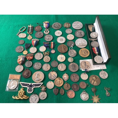 550 - A mixed group of approximately 60 medallions and medals including a badge for the Royal Marines (see... 