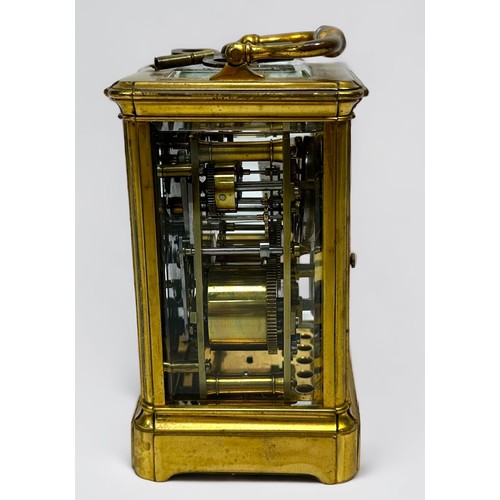 389 - A 19th century brass repeating carriage alarm clock, 8-day movement striking a bell, finely foliate-... 