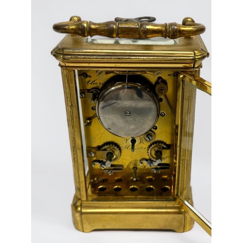 389 - A 19th century brass repeating carriage alarm clock, 8-day movement striking a bell, finely foliate-... 