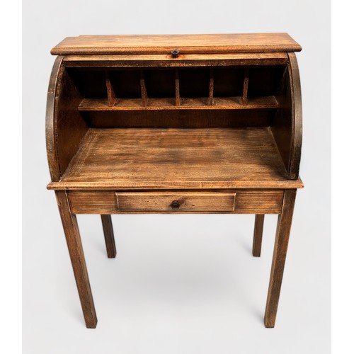 516 - An early 20th century stained oak child's roll-top desk, with enclosed pigeonholes, short frieze dra... 