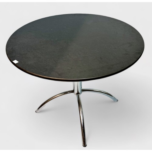 522 - A 20th century circular dining table with black granite top and chromium plated tubular steel quadri... 