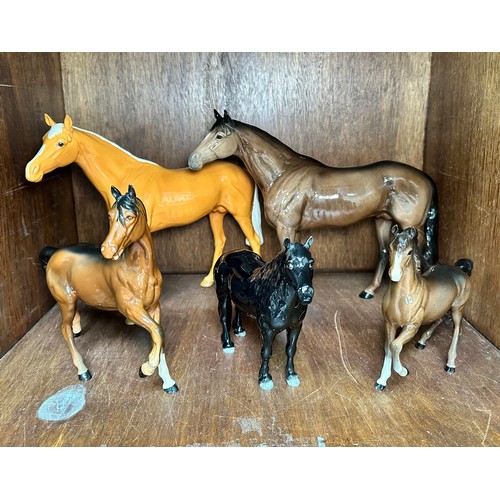 16 - Four assorted Beswick horses, comprising, two large racehorses, Palomino gloss and brown gloss finis... 