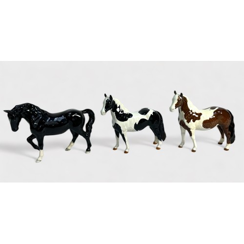 29 - A Beswick 'Stocky Jogging Mare,' model No. 855, BCC 2005, black gloss, together with a 'Piebald' and... 