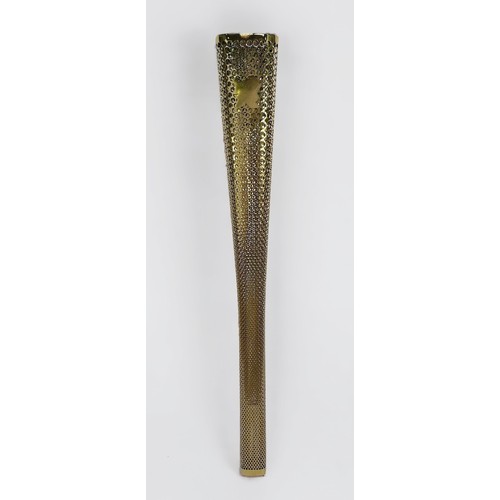 611 - A 2012 London Olympic Games Bearer's Torch, of tapering, triangular form, gold coloured, the applied... 