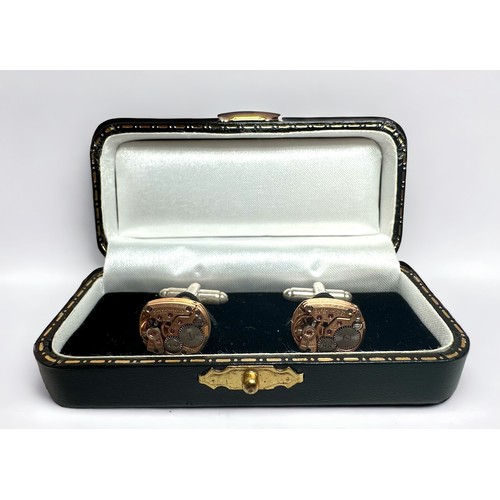 123 - Two pairs of cufflinks, one pair white metal, the other yellow metal, each modelled as Omega watch m... 