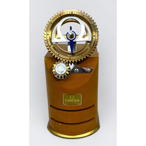 124 - A scarce Omega watch retail/dealer display stand, modelled with two interlocking and rotating batter... 