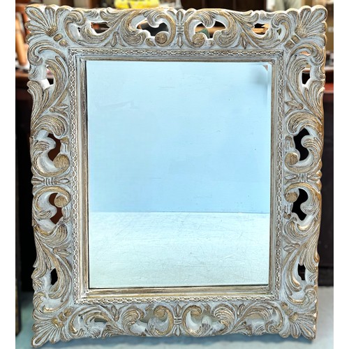 400 - A large composit framed wall mirror, moulded with scrolling acanthus and shell-capped corners, 'lime... 