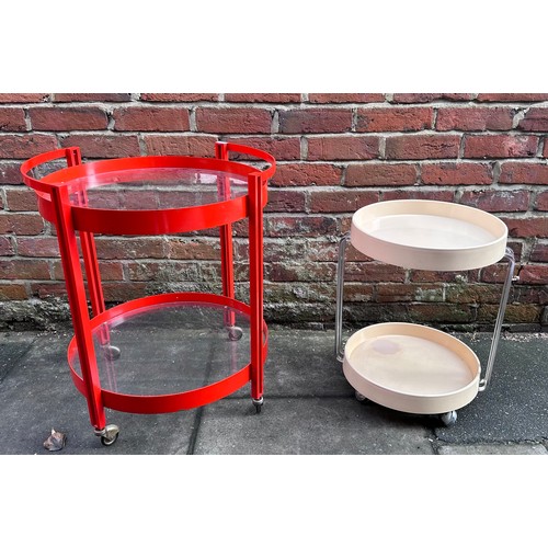 524 - A 1970s/80s red metal circular two-tier drinks trolly with glass top and undertier, 58cm diam, toget... 