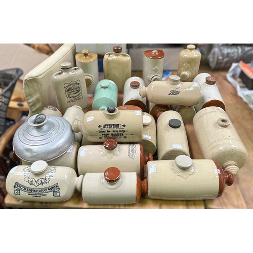 37 - A collection of 24x stonewrae pottery foot-warmers including Doulton, Timothy White, Denby, Boots, e... 