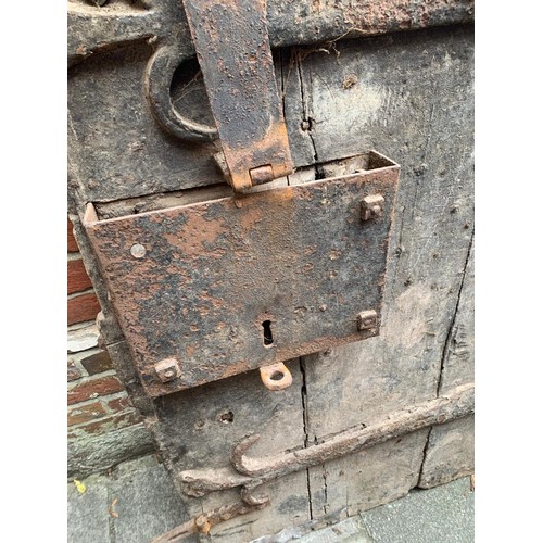 515 - An extremely heavy Medieval Oak lancet-shape castle door, of plank and ledge construction with origi... 