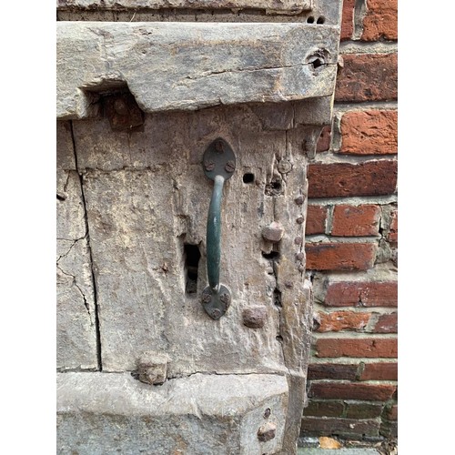 515 - An extremely heavy Medieval Oak lancet-shape castle door, of plank and ledge construction with origi... 