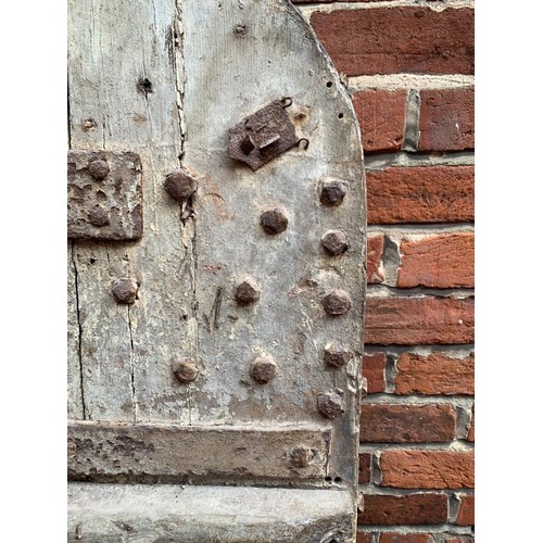 515 - An extremely heavy Medieval Oak lancet-shape castle door, of plank and ledge construction with origi... 