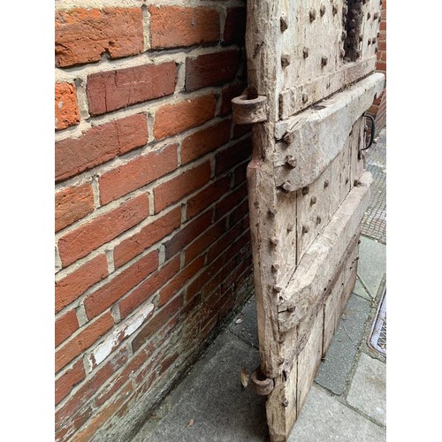 515 - An extremely heavy Medieval Oak lancet-shape castle door, of plank and ledge construction with origi... 