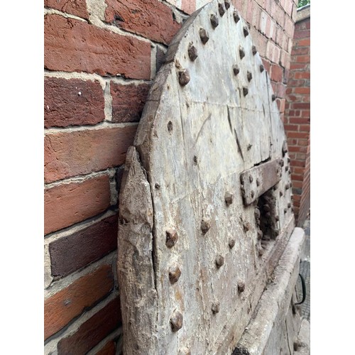 515 - An extremely heavy Medieval Oak lancet-shape castle door, of plank and ledge construction with origi... 