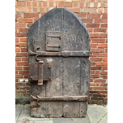 515 - An extremely heavy Medieval Oak lancet-shape castle door, of plank and ledge construction with origi... 