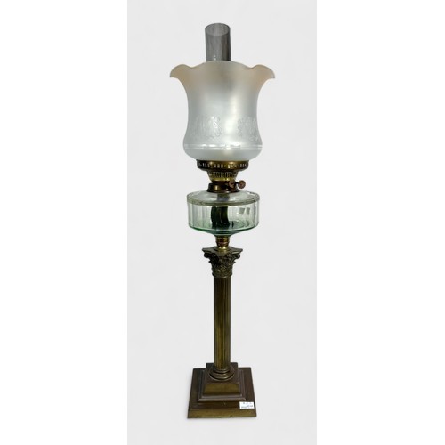 404 - A Victorian oil lamp, brass base of classicl column on stepped square base, glass resevoir and etche... 