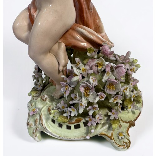 43 - A Sitzendorf porcelain centrepiece, modelled as a female cherub supporting a flower encrusted shell,... 