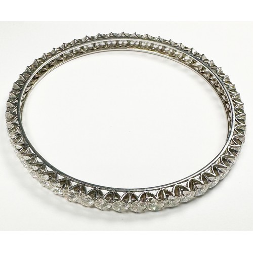 295 - An 18ct white gold diamond bangle, claw set with 50 x round brilliant cut diamonds, estimated total ... 