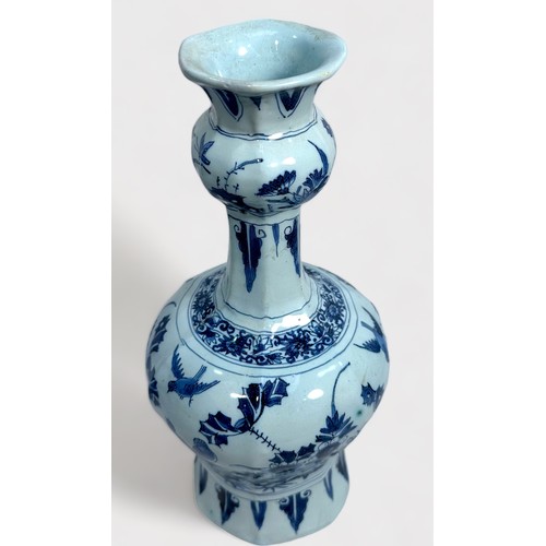 58 - A Dutch Delft pottery vase of hexagonal baluster form, decorated underglaze in cobalt blue with bird... 