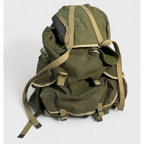 433 - A 1940s War Department issue Bergen together with a WD webbing belt and pounches, (2)