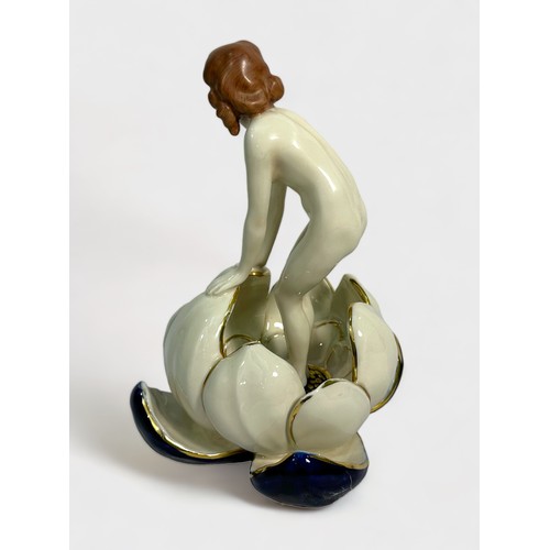 63 - A Royal Dux porcelain figure of a nymph emerging from a waterlily, applied triangle mark to base and... 