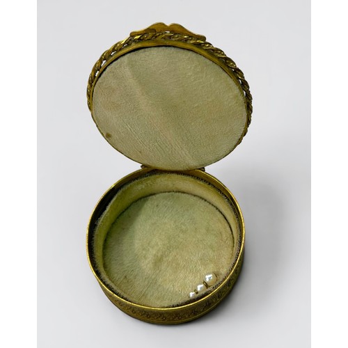 301A - An early 19th century gilt-brass circular box and cover, the top with central 'Gainsborough style' p... 