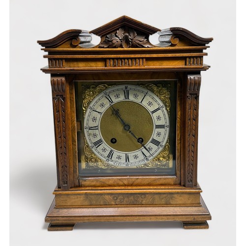 394 - An Edwardian Walnut cased mantel clock of classical temple form, with eight-day movement striking a ... 