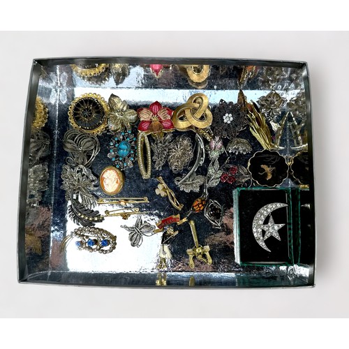 300 - A large collection of assorted brooches gem set examples, floral, animal and automobile design piece... 