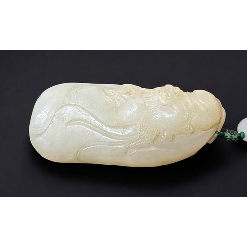 72 - A Chinese Qing Dynasty pale russet jade boulder pendant, or rubbing stone, finely carved as the Star... 