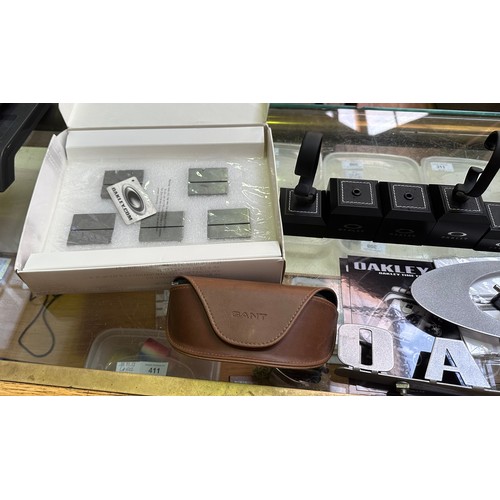 681 - A collection of assorted Oakley authorised dealer display stands for wristwatches and sunglasses, in... 