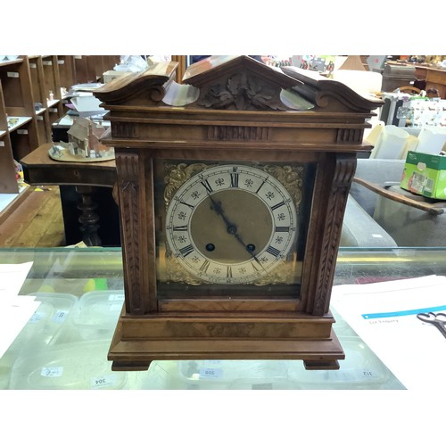 394 - An Edwardian Walnut cased mantel clock of classical temple form, with eight-day movement striking a ... 