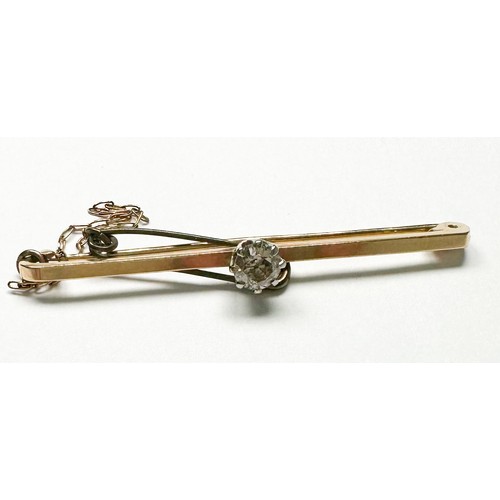 151 - A 9ct yellow gold bar-brooch with safety chain, claw set with a solitaire diamond to the centre, est... 