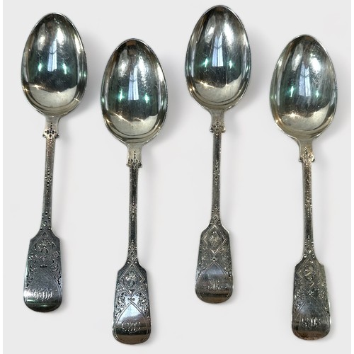 94 - A set of four Edwardian silver table spoons by Joseph Rodgers & Sons, with bright cut foliate decora... 