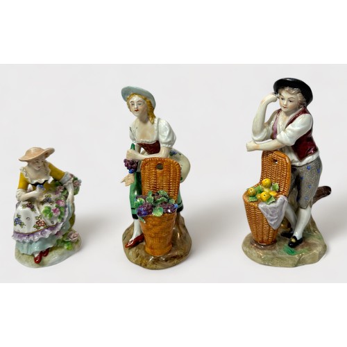 33 - A pair of 19th Century Sitzendorf porcelain figures of fruit sellers, 11cm, and another of a flower ... 