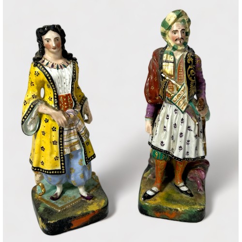 32 - A pair of 19th century continental porcelain figures of an Ottoman couple, painted in polychrome ena... 