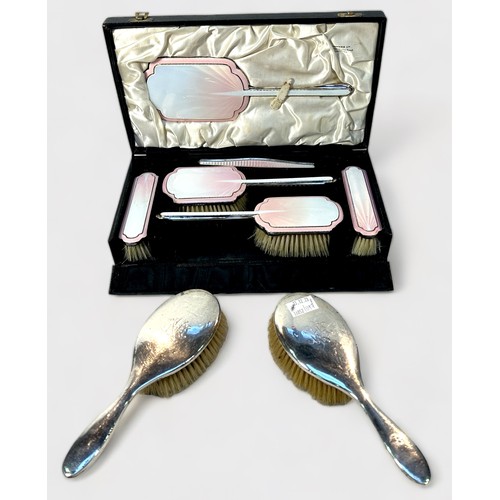103 - A six-piece silver and pink guilloche enamel dressing table set by Albert Carter, comprising four br... 