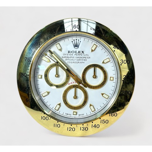 138 - A Rolex authorised dealer display wall clock, modelled as a Rolex Daytona, the white dial with gilt ... 