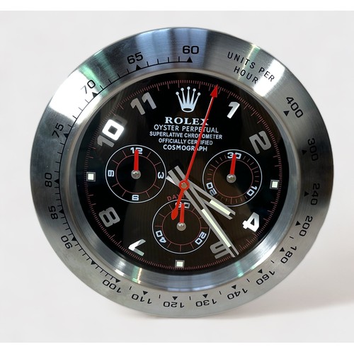 136 - A Rolex authorised dealer display wall clock, modelled as a Rolex Daytona, the black dial with Arabi... 