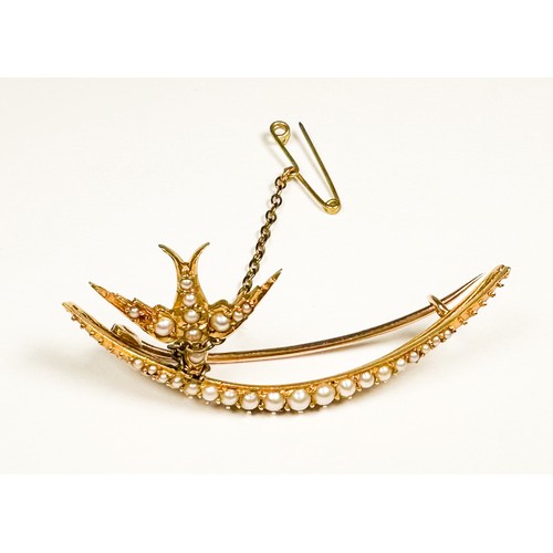 164 - An unmarked Edwardian gold and seed pearl brooch, of crescent form, set with graduated blister seed ... 