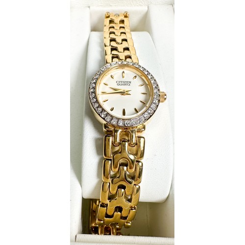 175 - A gold plated wristwatch by Citizen, with oval shaped face and white faceted stones set to the bezel... 